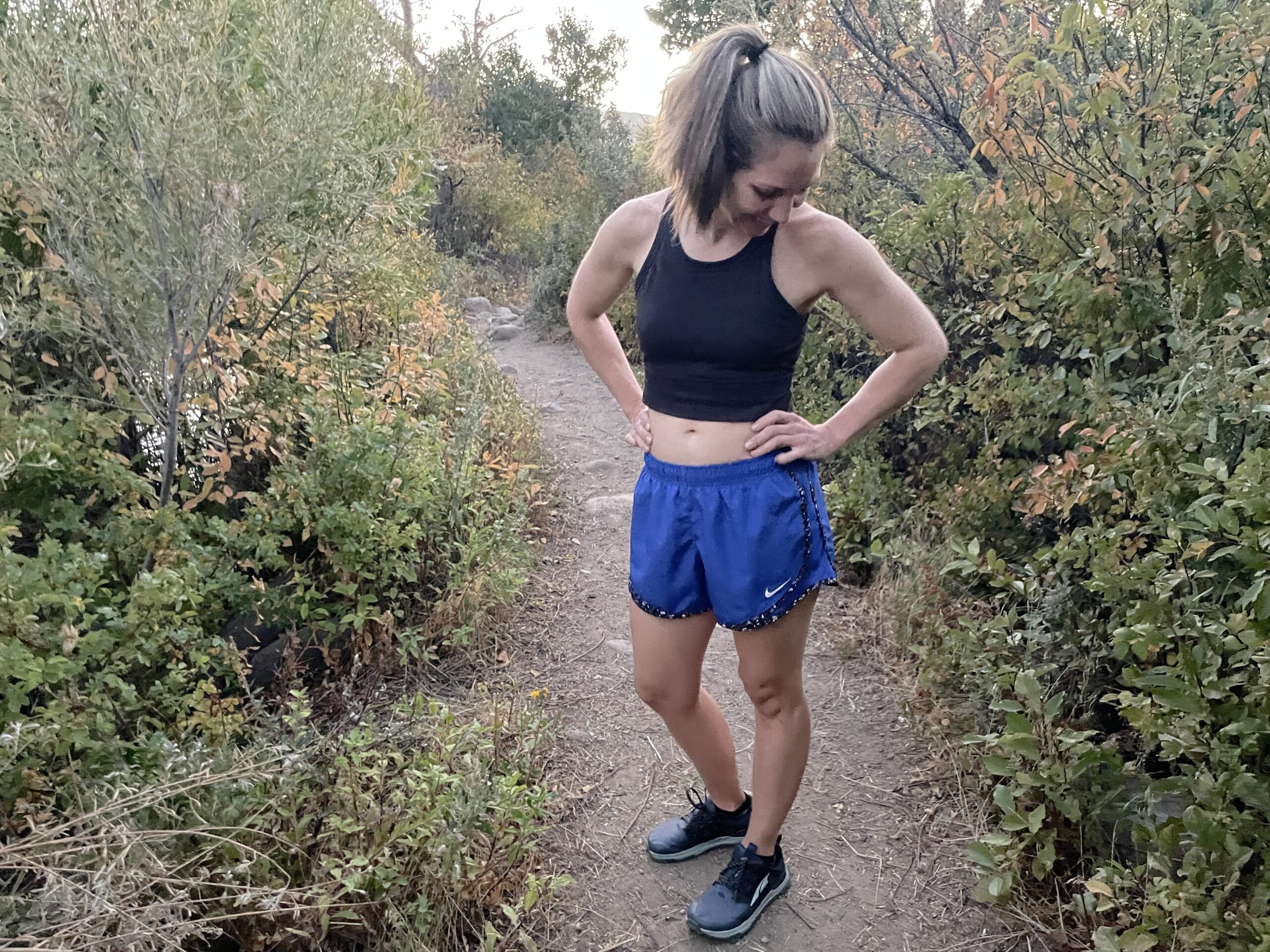 woman wearing nike shorts on a trail