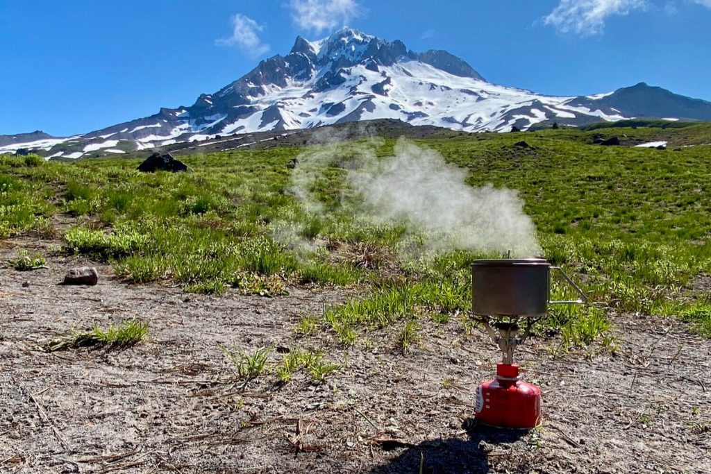 Boiling water with the MSR Pocket Rocket 2 in front of a mountain
