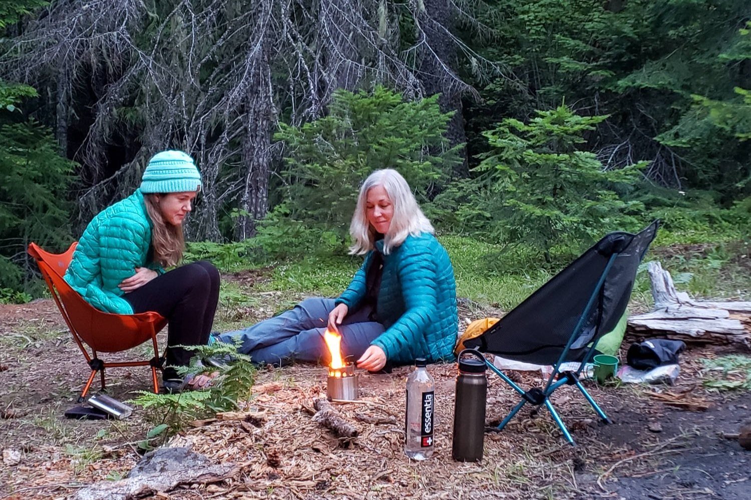 campers watch fire in solo stove while in camp