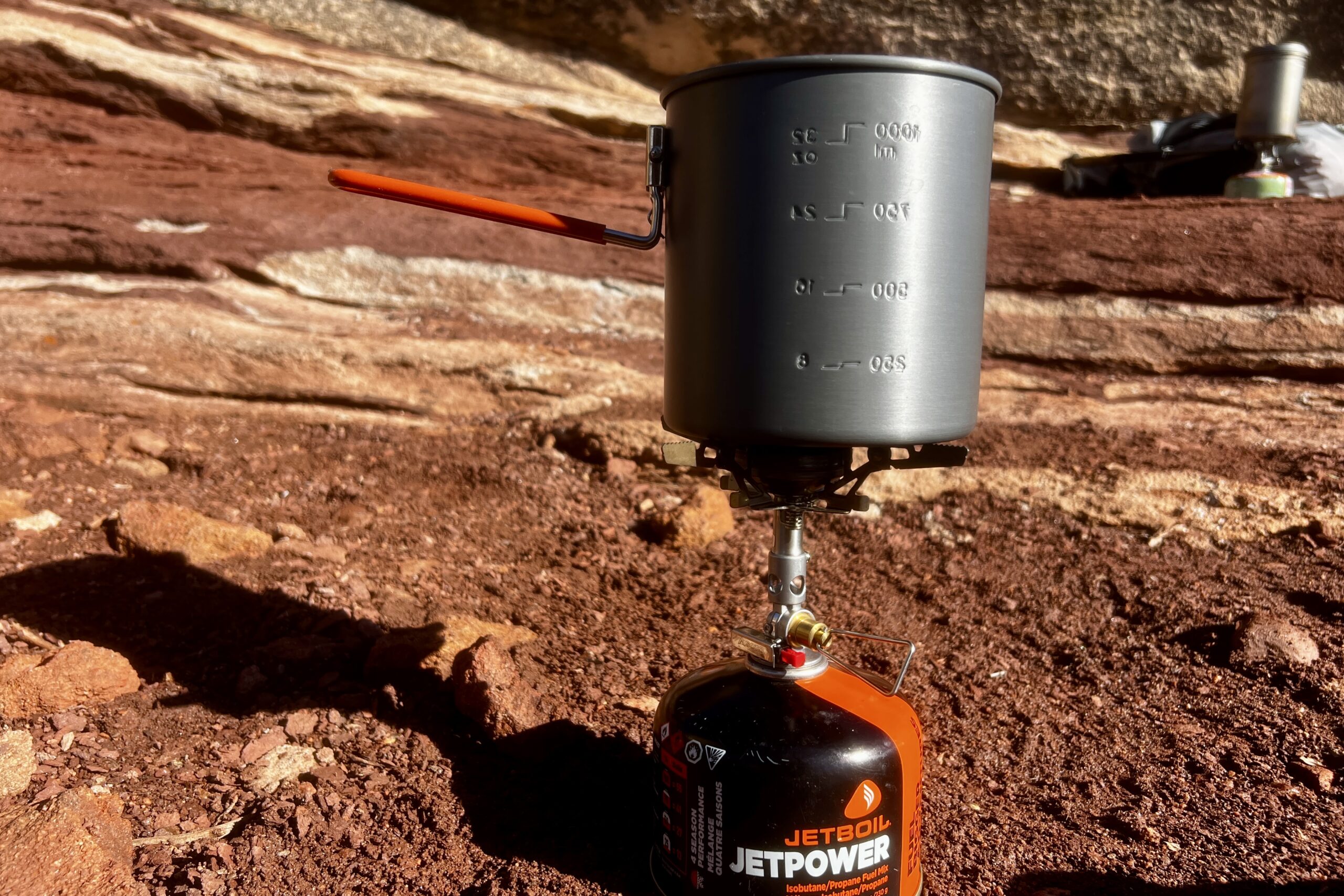 The gsi halulite boiler sits on a stove with red rock formations in the background.
