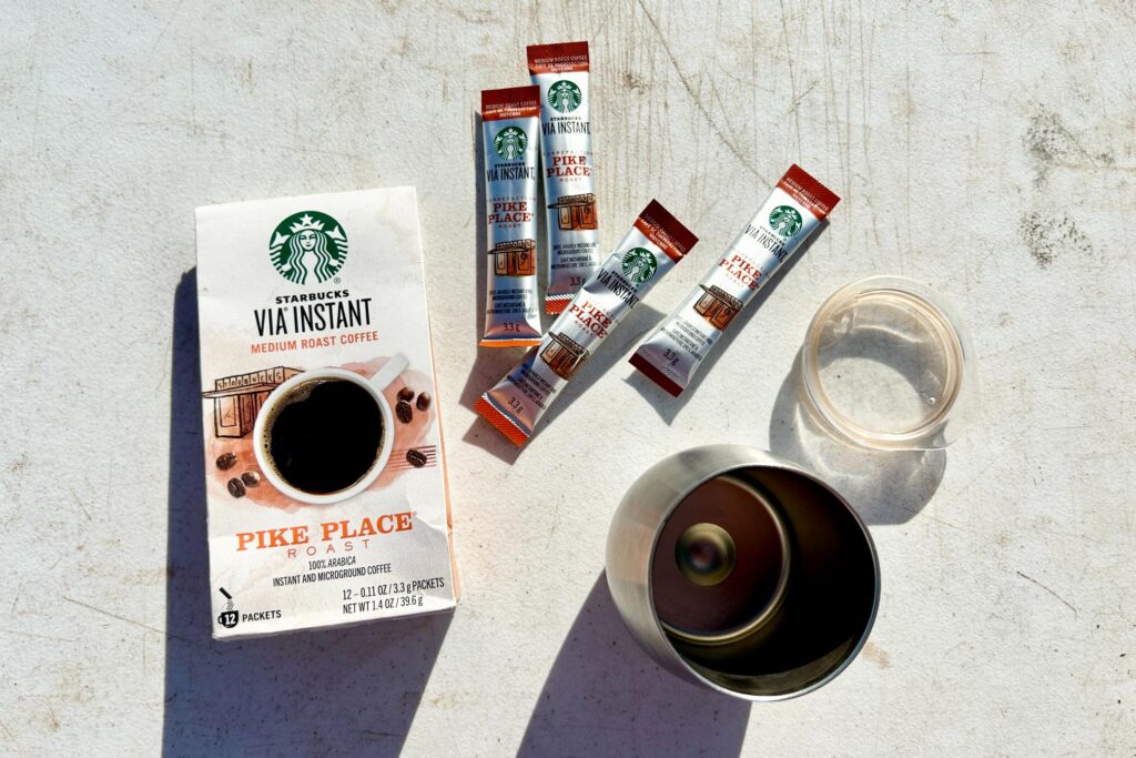 Starbucks Via instant coffee packets with a mug on a table