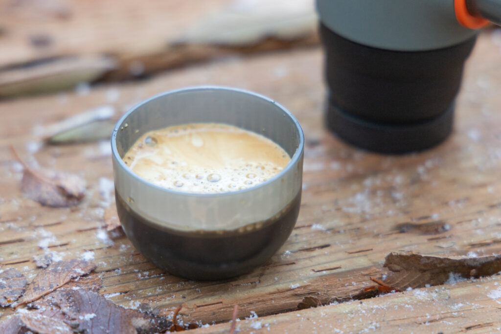A shot of espresso topped with crema as extracted by the Wacaco Minipresso.