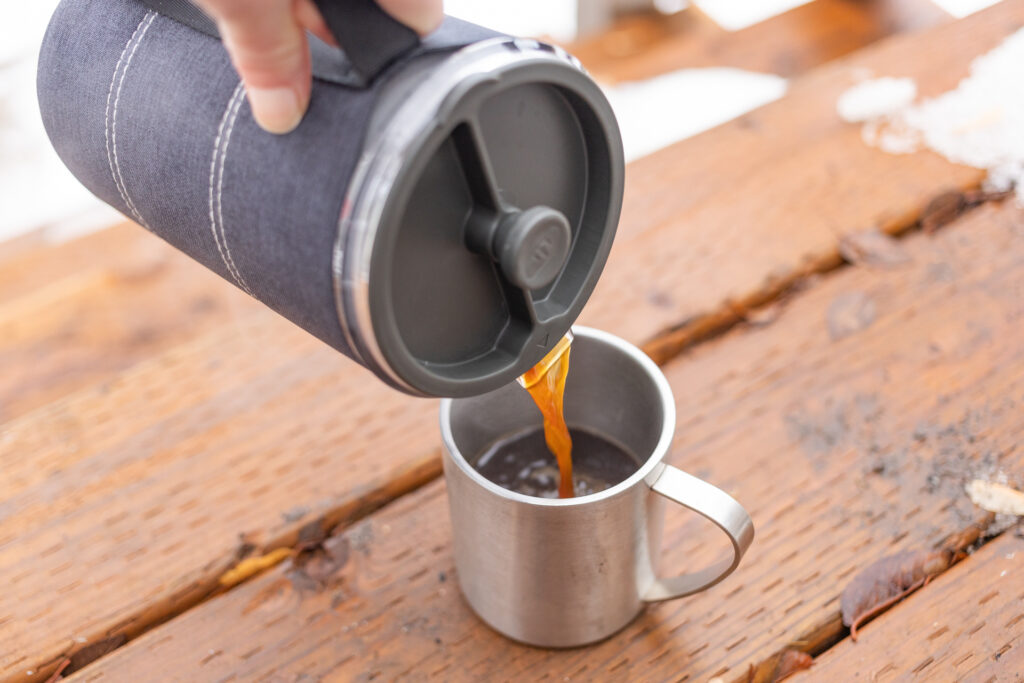 Pouring coffee into a mug with the GSI Java Press.