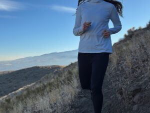 woman hiking and running through high desert