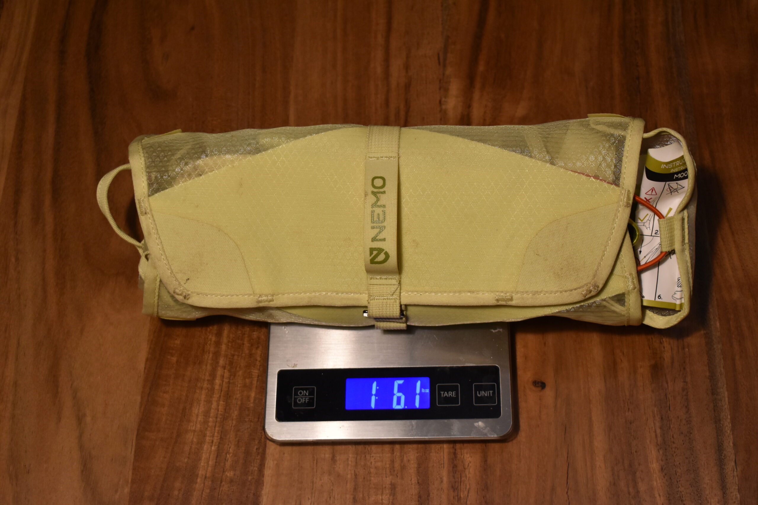 The packed NEMO recliner sits on a kitchen scale that reads 1 lb 6 oz