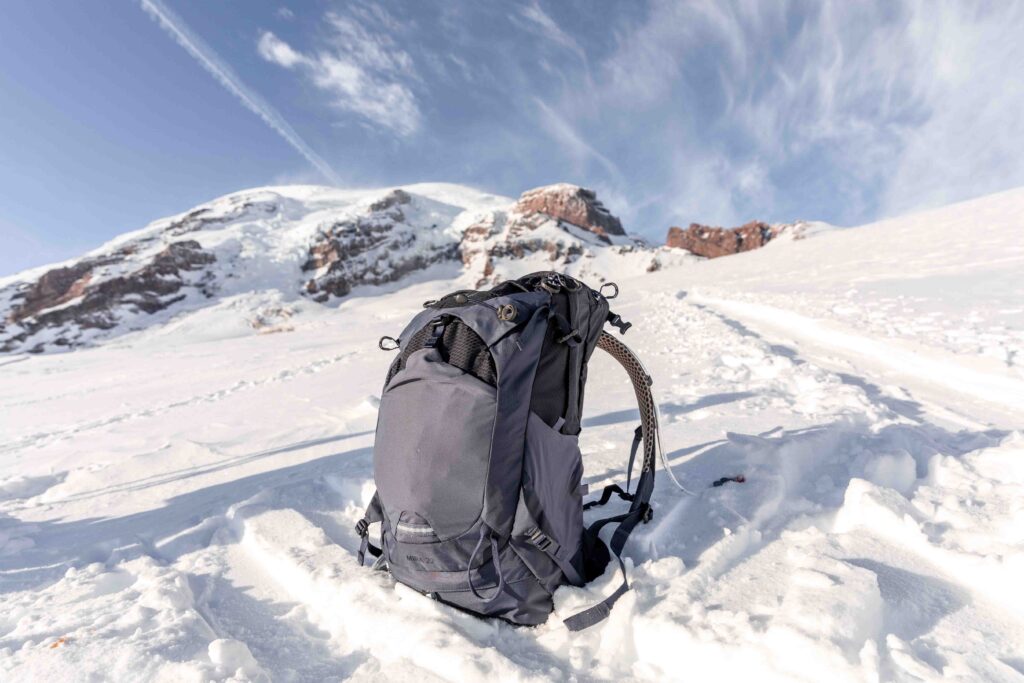 Details of Osprey Mira 22- Pack is sitting on snow on a sunny day