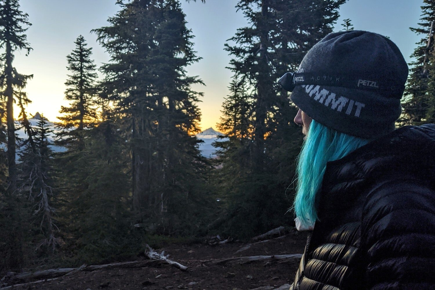 Profile-view-of-a-woman-wearing-the-Petzl-Actik-headlamp-at-dusk