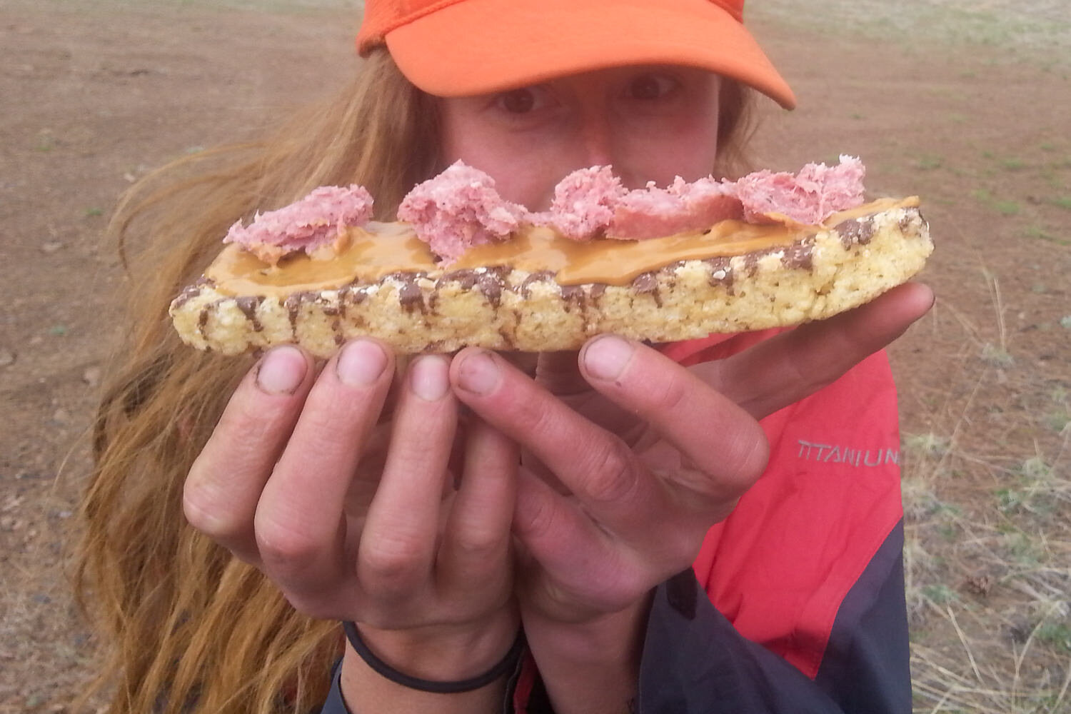 backpacker holding up a handmade snack