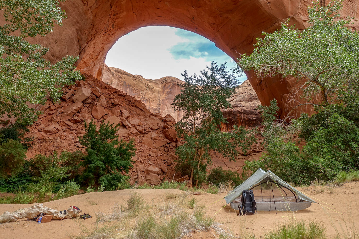 The Zpacks Duplex pitched near a red rock arch in Coyote Gulch.